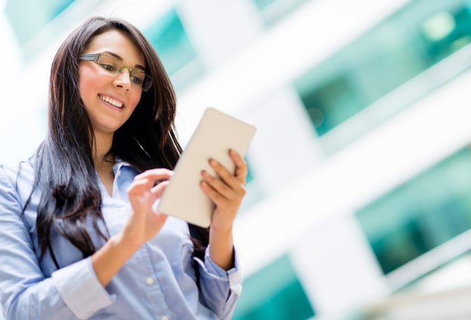 Happy business woman using a tablet computer